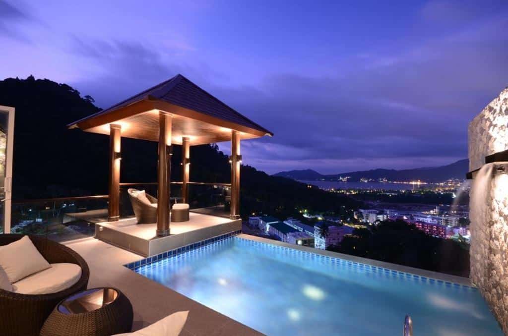 Rooftop pool with a night view at AW ONE Patong Beach Villa