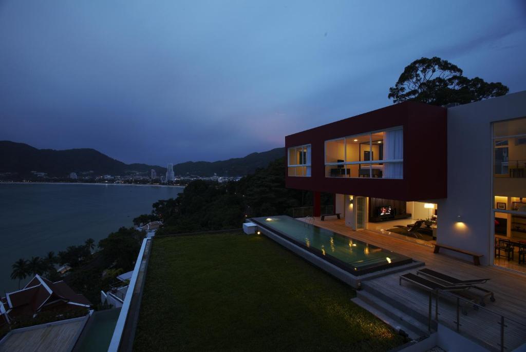 Nighttime exterior view of beachfront with pool at Jirana Villa in Patong Beach