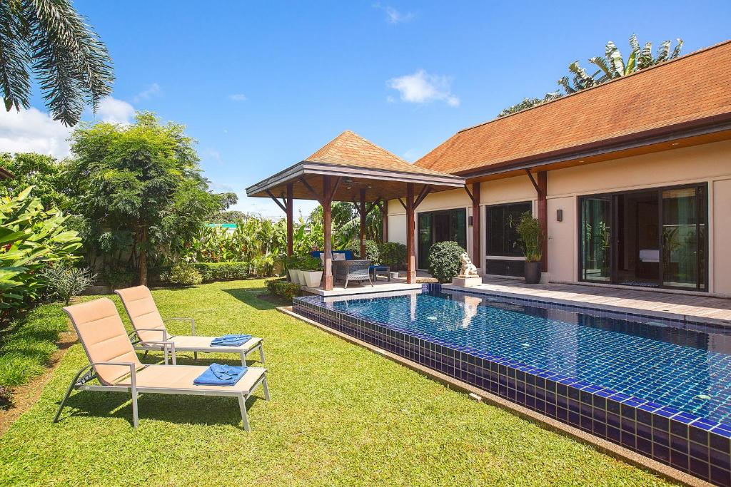 Private pool with lounge chair at  Kokyang Estate villa in Nai Harn Beach