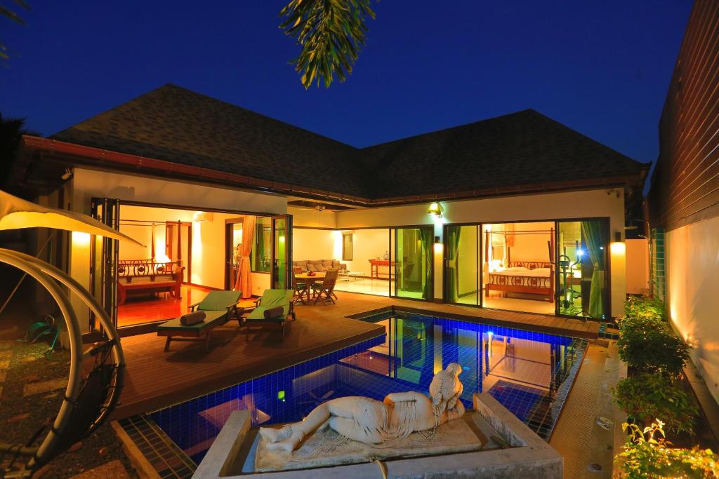 Exterior night view with swimming pool at Naiharn Beach Villa in Nai Harn Beach