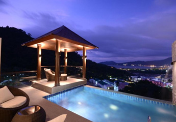 Rooftop pool night view at AW ONE Phuket Villas with chef near Patong Beach